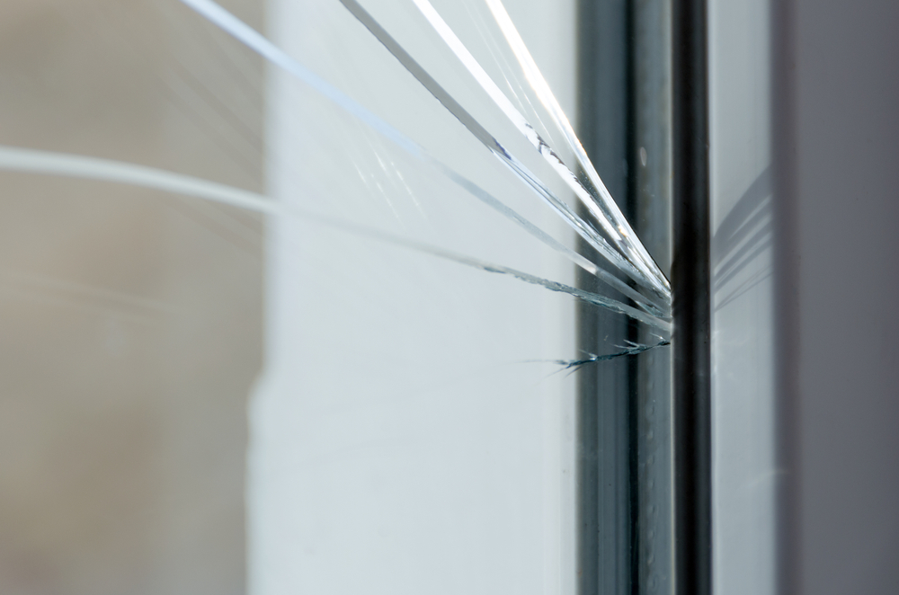 Cracked,glass.,plastic,window,is,damaged,by,cracks.