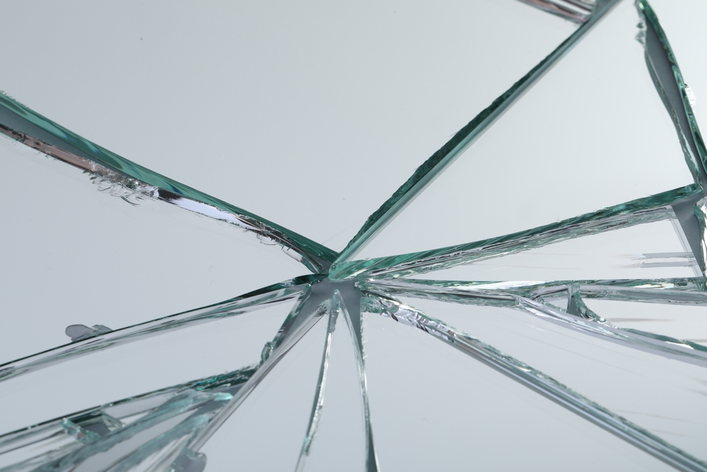 Broken,mirror,with,many,cracks,as,background,,closeup,view